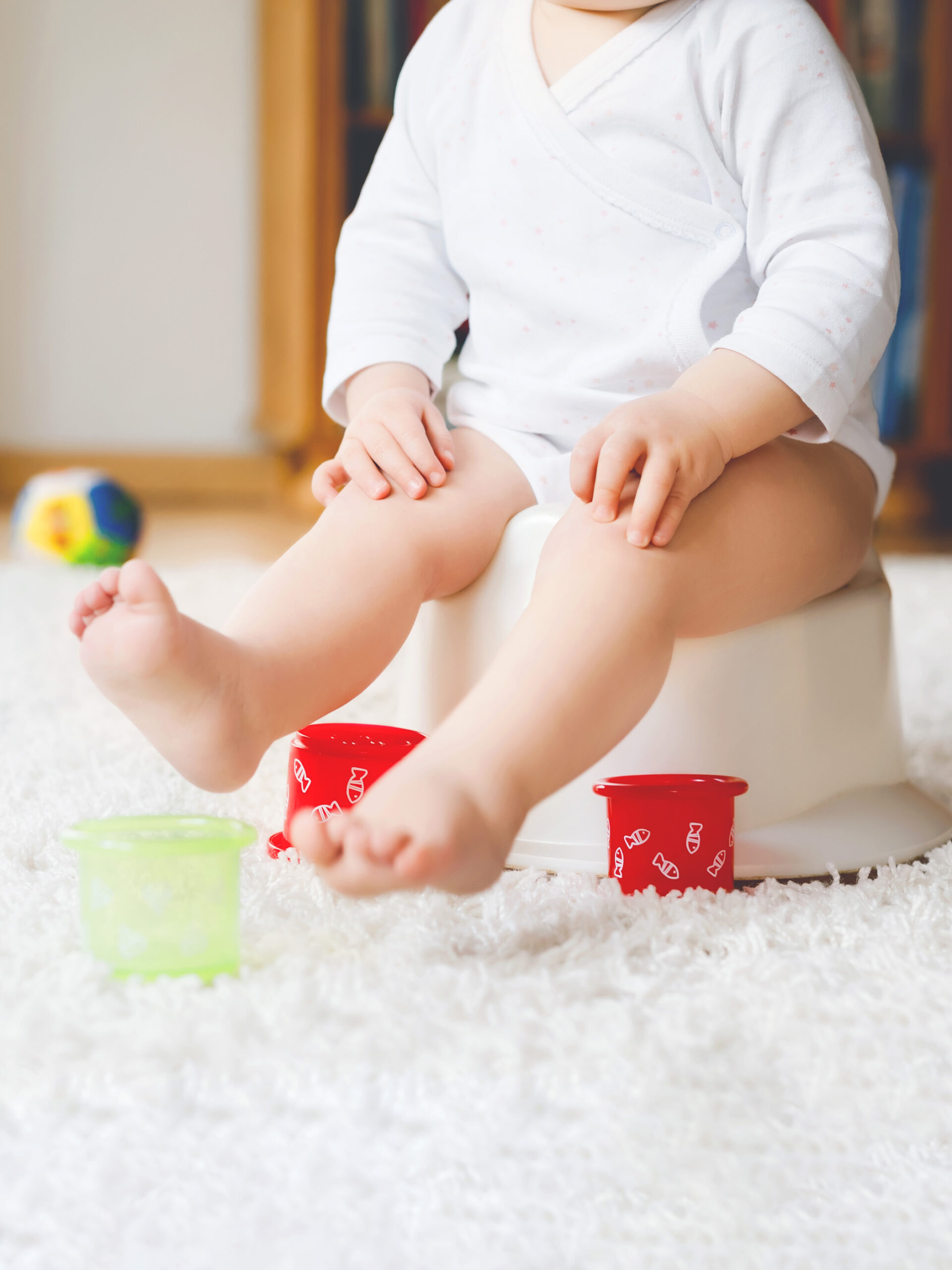 Child sits on potty-training toilet